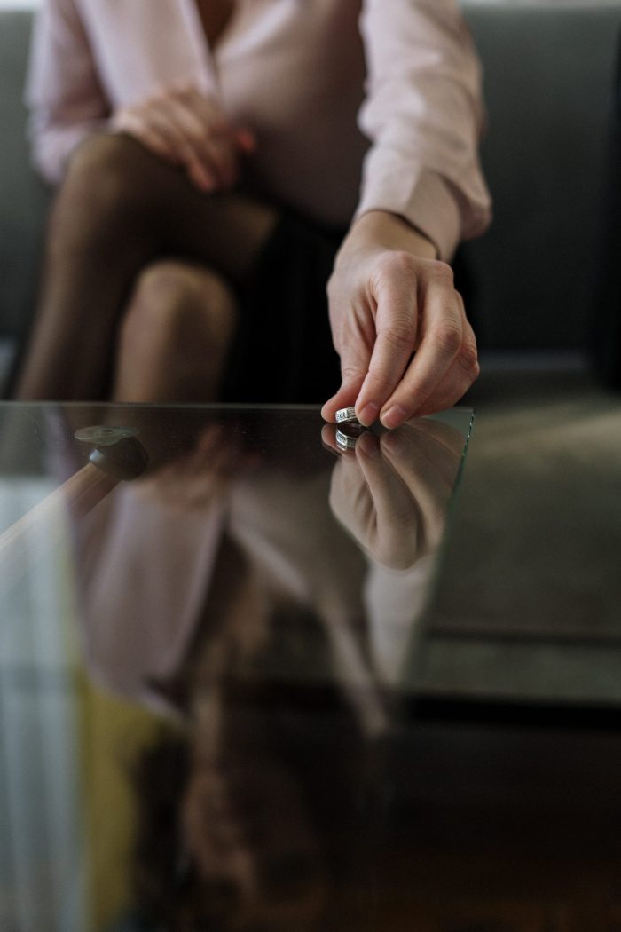 Woman placing ring on table